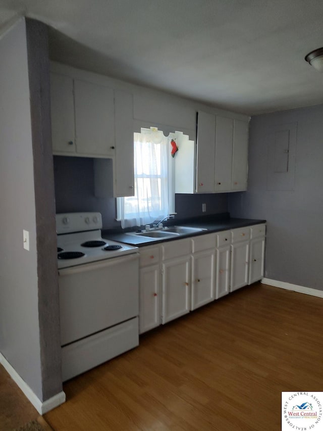 kitchen featuring dark countertops, white cabinets, electric stove, and wood finished floors