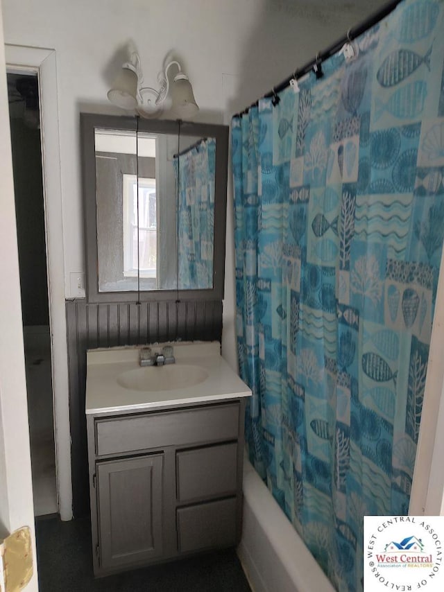 bathroom featuring shower / bathtub combination with curtain and vanity