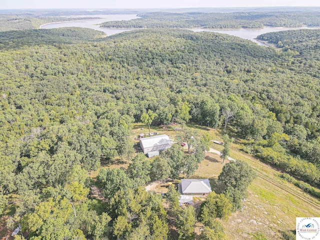 drone / aerial view featuring a water view and a forest view