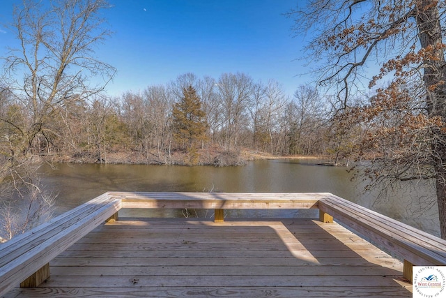 view of dock featuring a water view and a view of trees