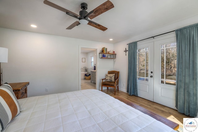 bedroom with a ceiling fan, wood finished floors, recessed lighting, french doors, and ensuite bathroom