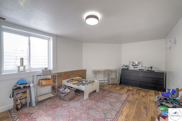 bedroom featuring a textured ceiling and wood finished floors