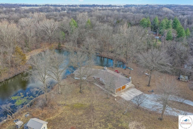 aerial view featuring a forest view and a water view