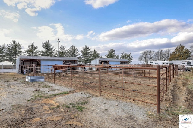 view of yard featuring an exterior structure, a rural view, and an outdoor structure