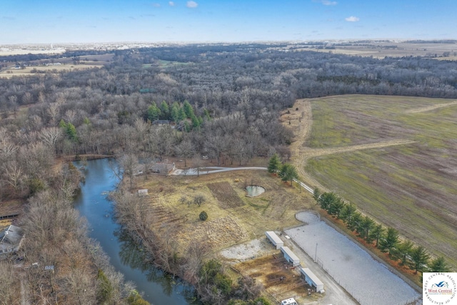 bird's eye view featuring a forest view and a water view