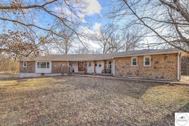 ranch-style house featuring covered porch and stone siding