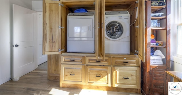 laundry area featuring washer and dryer, wood finished floors, and laundry area