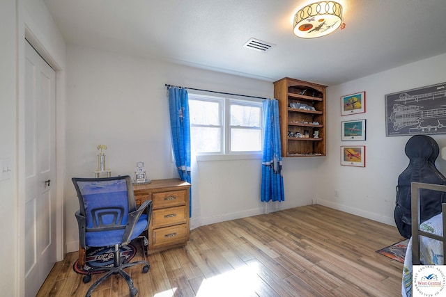 office with visible vents, baseboards, and light wood-style flooring