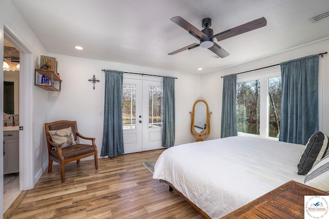 bedroom featuring visible vents, light wood finished floors, recessed lighting, access to exterior, and french doors