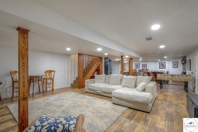 living area with recessed lighting, stairway, visible vents, and wood finished floors