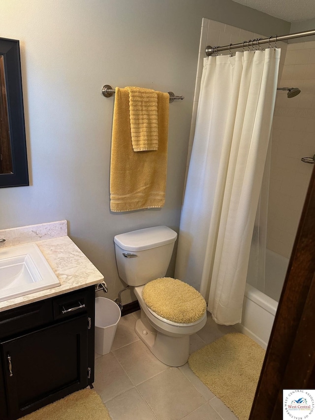 full bathroom with tile patterned flooring, vanity, toilet, and shower / bath combo with shower curtain