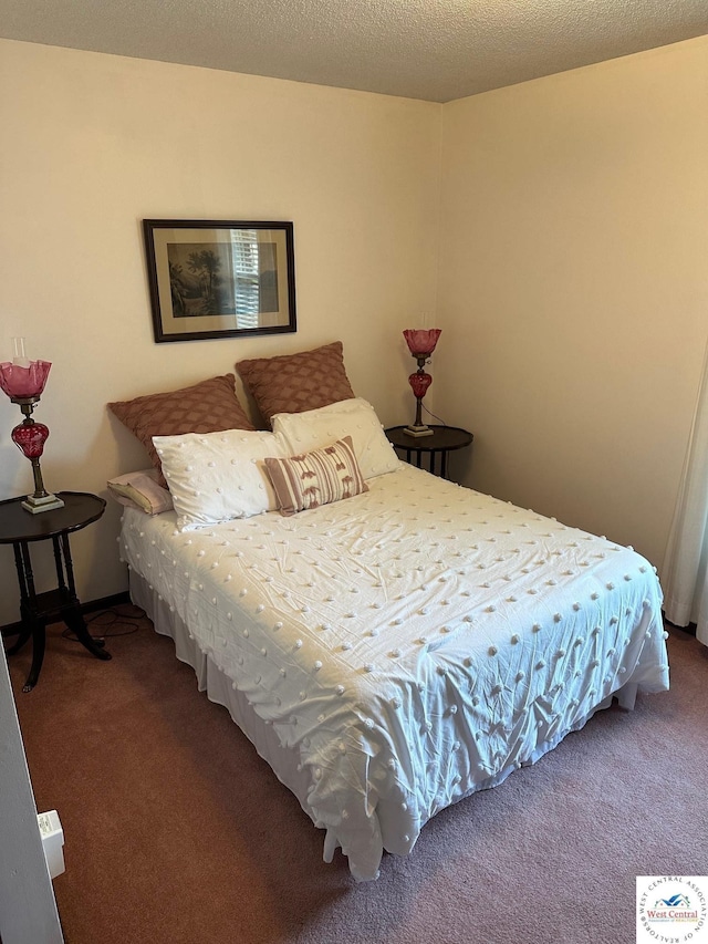 carpeted bedroom with a textured ceiling