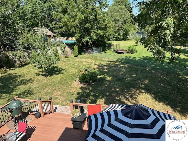 view of yard featuring fence and a deck