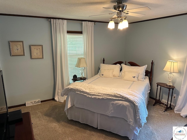 carpeted bedroom with a textured ceiling, ornamental molding, and visible vents