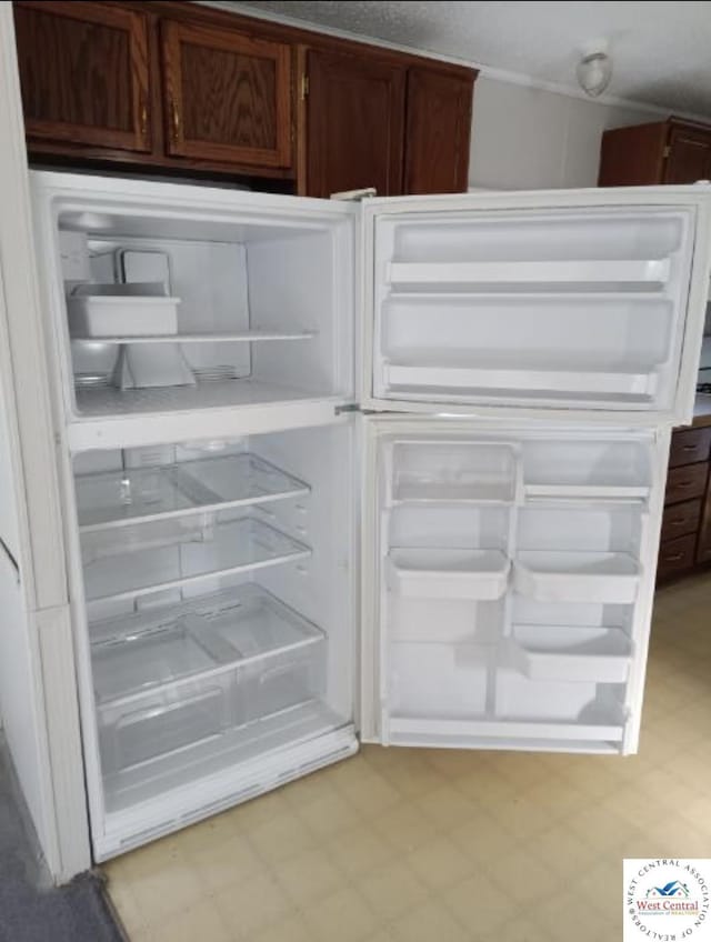 details featuring refrigerator and light floors