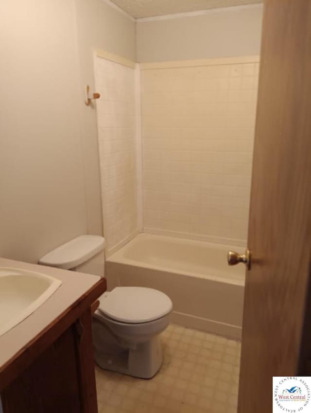 full bath featuring toilet, tile patterned floors, a textured ceiling, vanity, and shower / bathing tub combination