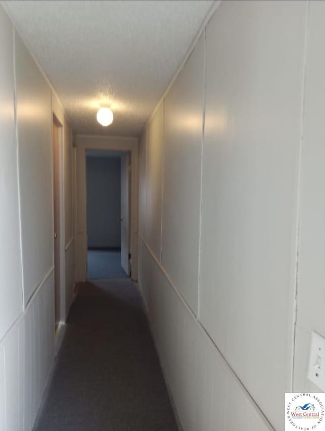 hallway featuring a textured ceiling