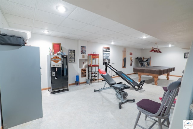 workout area with baseboards, recessed lighting, a paneled ceiling, and light colored carpet