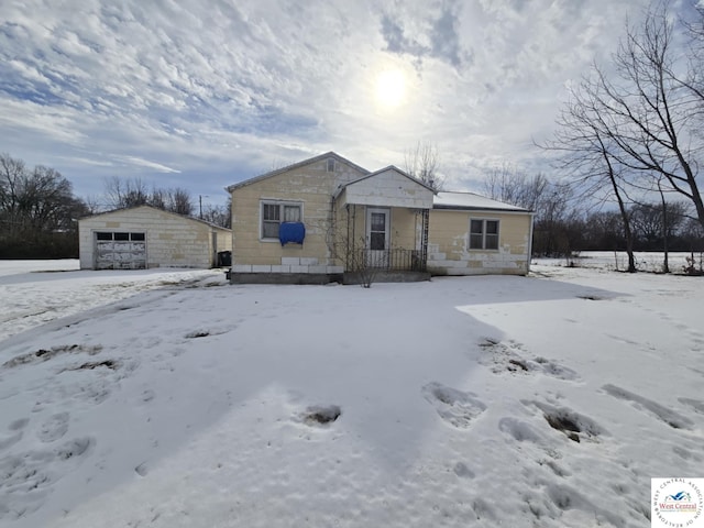 view of front of property featuring a garage and an outbuilding