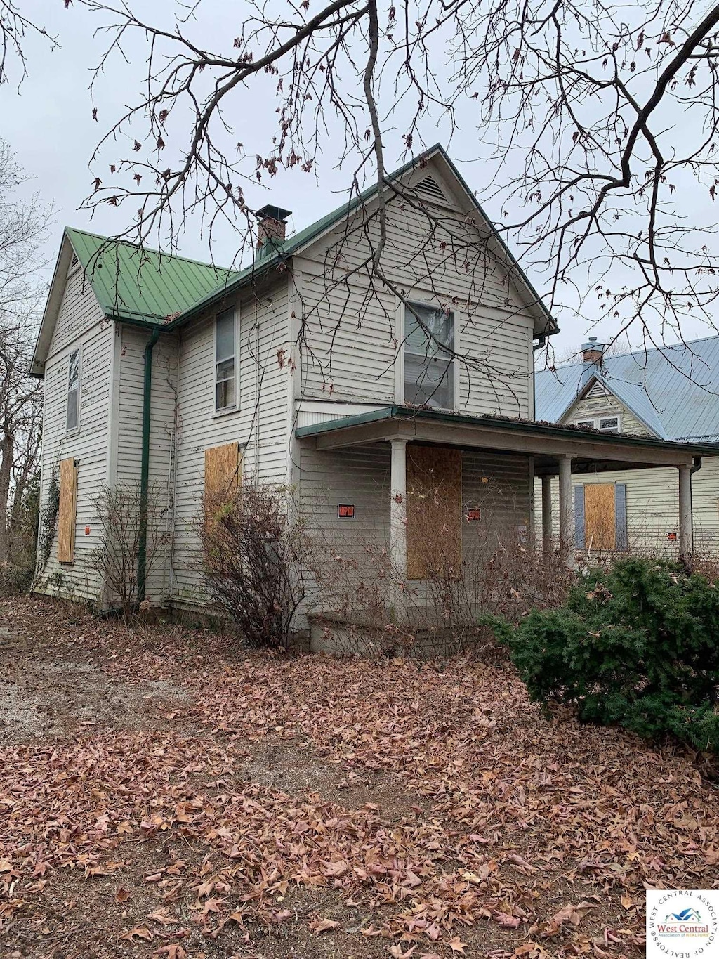 exterior space with metal roof and a chimney