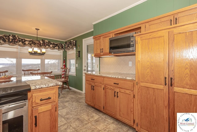 kitchen with tasteful backsplash, a chandelier, pendant lighting, ornamental molding, and appliances with stainless steel finishes