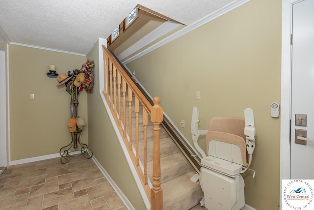 stairway featuring stone finish flooring, baseboards, a textured ceiling, and ornamental molding