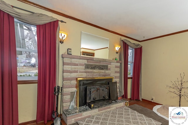 living room with crown molding, baseboards, and wood finished floors