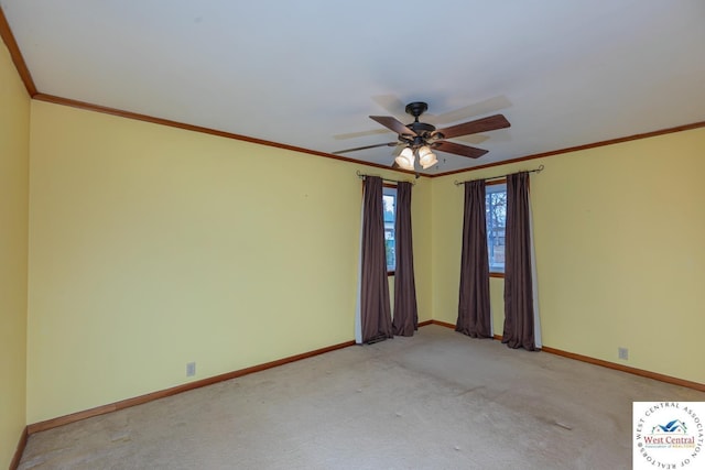 spare room featuring light carpet, a ceiling fan, crown molding, and baseboards