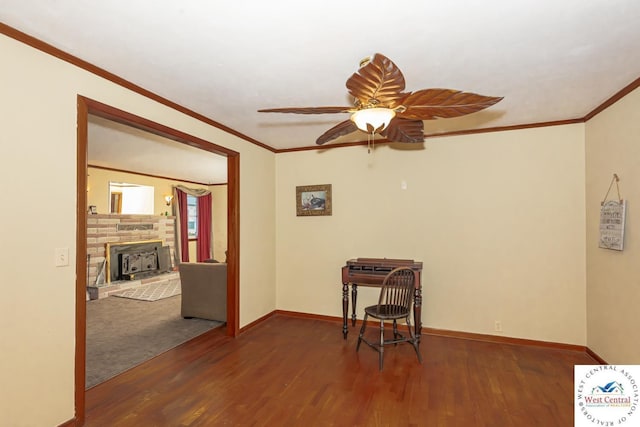 interior space featuring ceiling fan, crown molding, baseboards, and wood finished floors