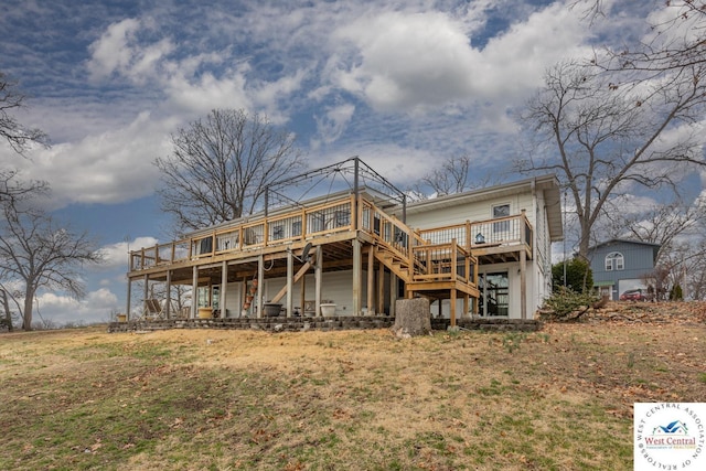 rear view of property with stairway and a deck