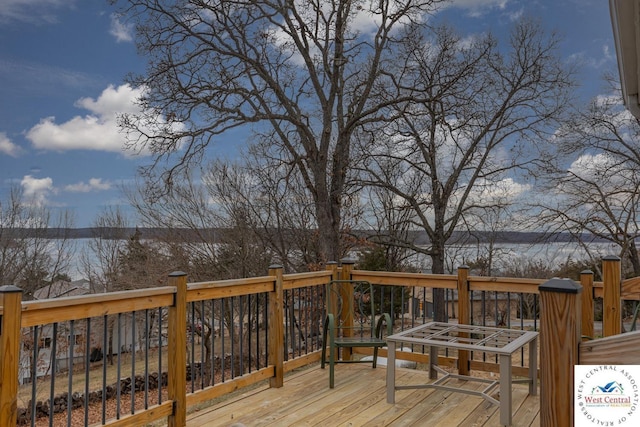 wooden deck featuring a water view