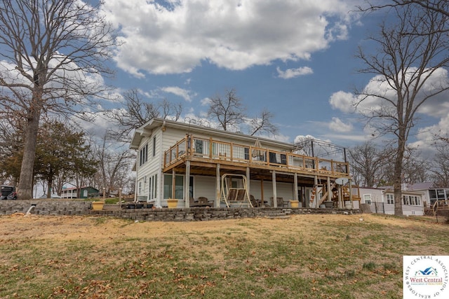 rear view of property with stairway, a lawn, and a wooden deck