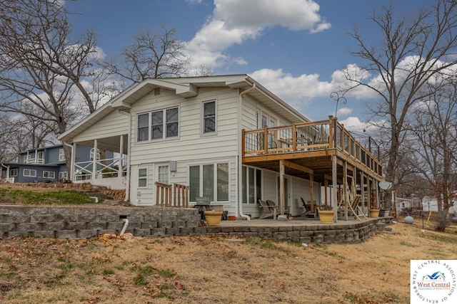 rear view of property featuring a deck, stairway, and a patio