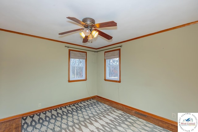 unfurnished room featuring ceiling fan, wood finished floors, baseboards, and ornamental molding