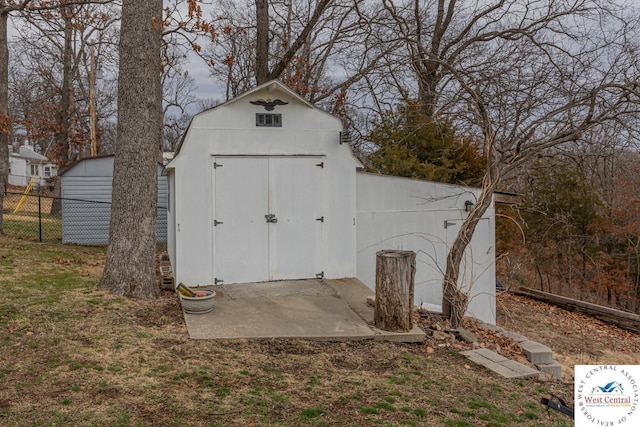 view of shed with fence