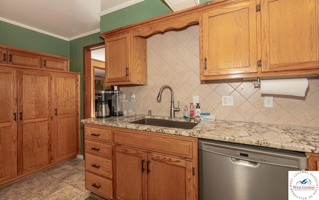 kitchen featuring a sink, backsplash, stainless steel dishwasher, crown molding, and light stone countertops