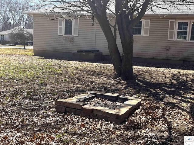 view of home's exterior with a fire pit