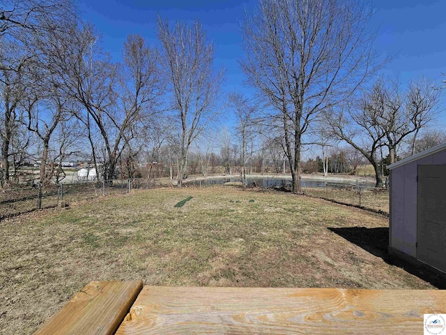 view of yard with an outdoor structure and a fenced backyard