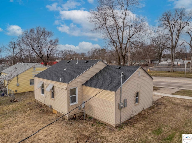 back of property with a shingled roof