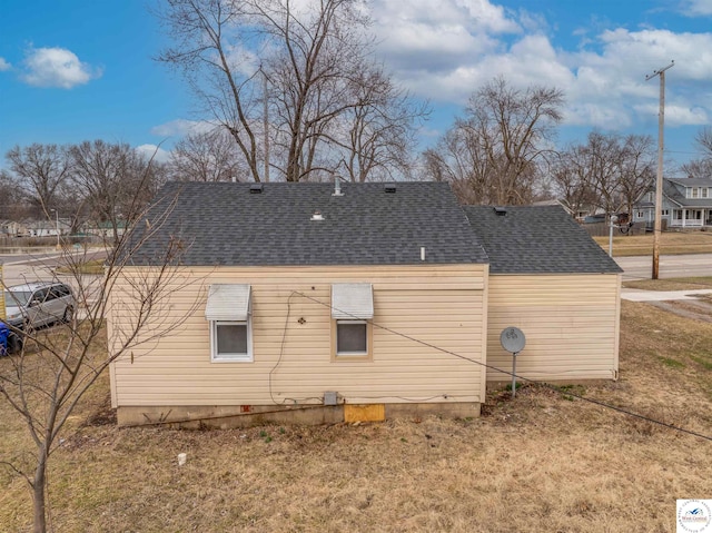 view of home's exterior with a shingled roof