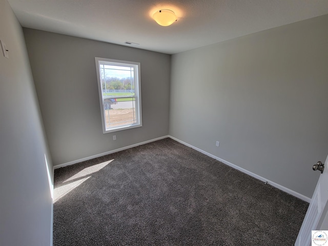 spare room featuring baseboards, visible vents, and carpet flooring