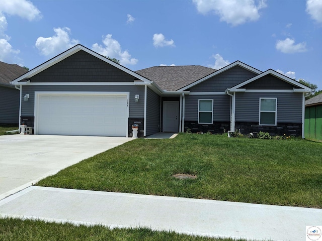 view of front of house with a garage, stone siding, a front lawn, and driveway