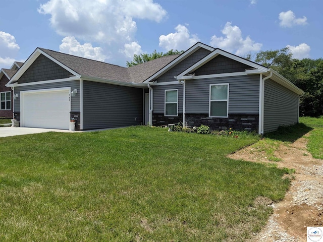 view of front of house featuring a garage, stone siding, a front yard, and driveway