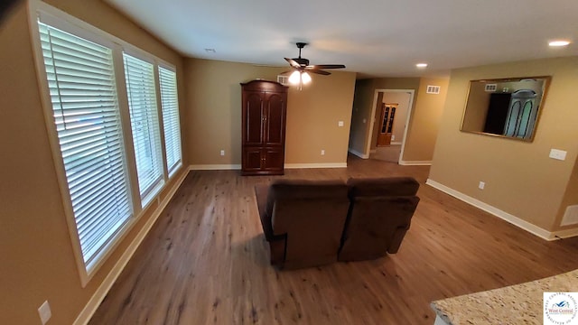 unfurnished living room featuring visible vents, baseboards, ceiling fan, wood finished floors, and recessed lighting