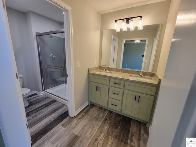 full bath featuring a sink, toilet, and a shower stall