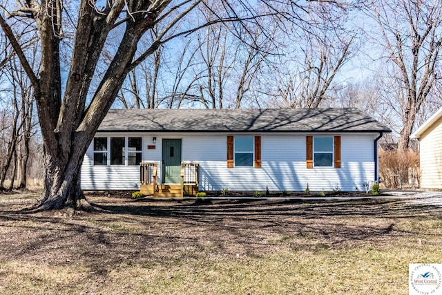 single story home with roof with shingles