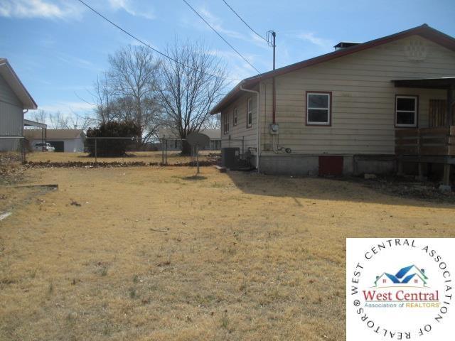 view of property exterior featuring a lawn and cooling unit