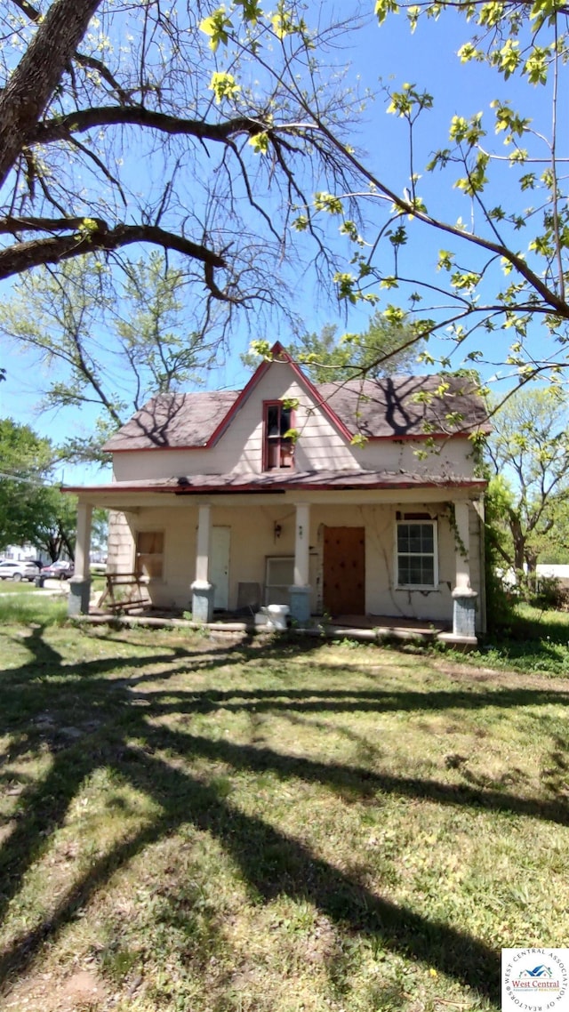 bungalow-style home with a front lawn