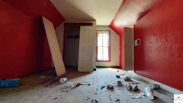 additional living space featuring visible vents and vaulted ceiling