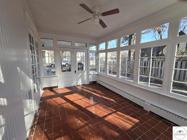 unfurnished sunroom featuring a baseboard radiator and ceiling fan